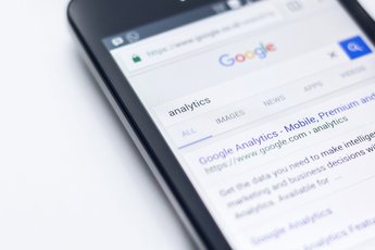 Mobile phone on Google with the search results for 'analytics'