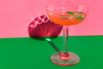 Cocktail glass on a pink and green backdrop